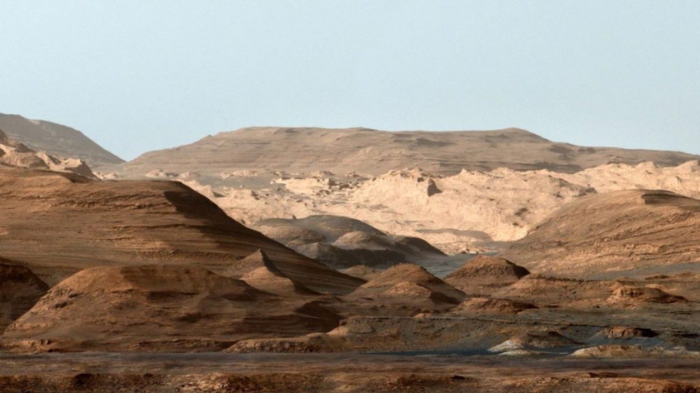 False-color image of Mount Sharp from inside the Gale Crater showing the everchanging planetary environment. Note that the sky is not blue on Mars but it was done deliberately to enhance the researchers' ability to distinguish the different stratification layers. Credit: NASA/JPL