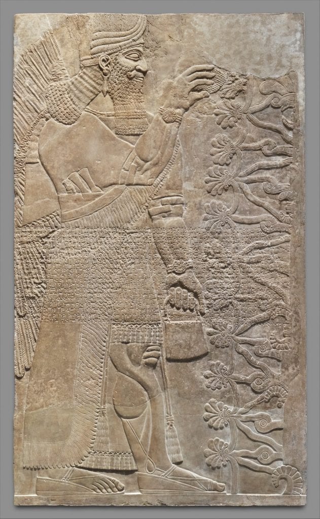 An Assyrian Relief Panel either depicting a king or an Anunnaki deity holding the Bag of the Gods. Credit: Metropolitan Museum 