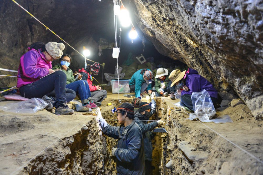 Researchers in the dugout they were allowed to make in the frozen floor of the caves. 