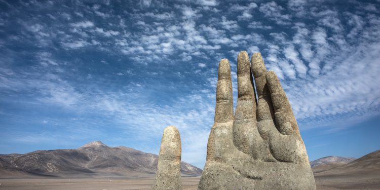 The massive sculpture in the middle of the Chilean desert respectively called the Hand of the Desert. Credit: DepositPhotos