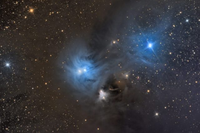 This image show two spectacular reflection nebulae are in the constellation Corona Australis. They are the result of a few very bright stars in a large, dusty cloud. This area is 500 light years from Earth. Shutterstock.