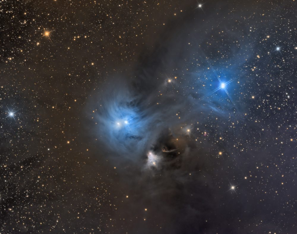 This image show two spectacular reflection nebulae are in the constellation Corona Australis. They are the result of a few very bright stars in a large, dusty cloud. This area is 500 light years from Earth. Shutterstock.