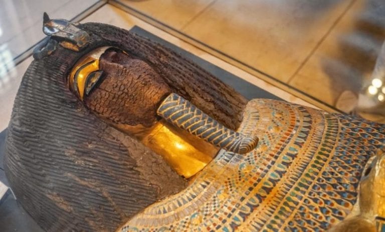 mummies with a gold sarcophagus