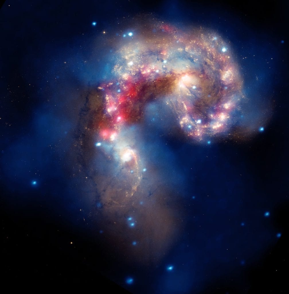 See the incredible shape of the Antennae galaxies in this composite image by Hubble and Chandra. Credit: NASA, ESA, SAO, CXC, JPL-Caltech, and STScI