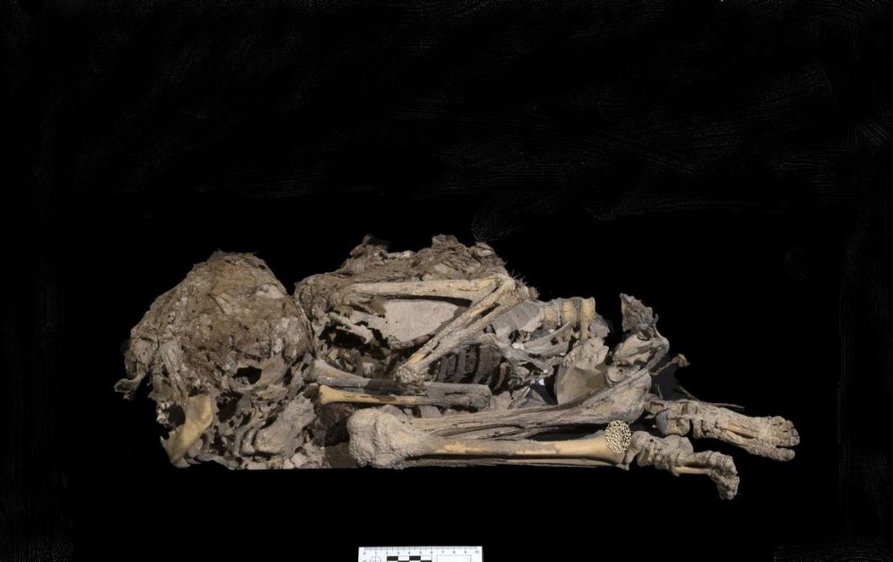 Besides the fragments of the Dead Sea Scrolls and the basket, scientists found this mummy of a child buried wrapped in cloth. Credit: Emil Aladjem / Israel Antiquities Authority