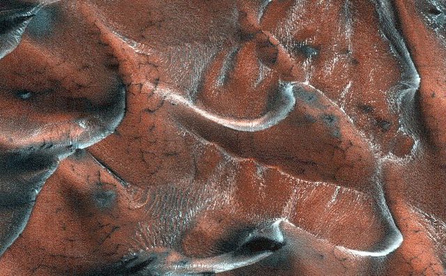 This image of sand dunes presents a 5-kilometer diameter field within a frosted crater in northern Mars. You can see a variety of dunes with different patterns and textures. Credit: NASA/JPL/University of Arizona