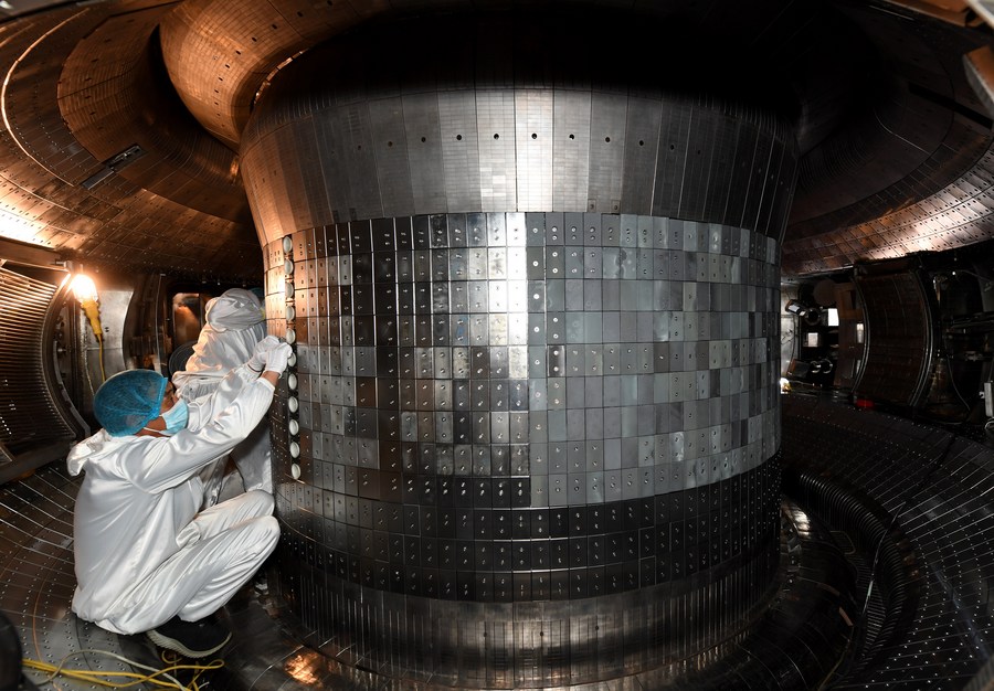Scientists working inside the experimental advanced superconducting tokamak. Credit: Xinhua/Liu Junxi
