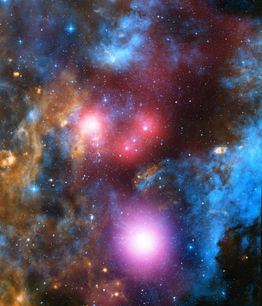 Composite image of Cygnus OB2 with X-Ray data from Chandra (red and blue). Credit: X-ray: NASA/CXC/SAO/J. Drake et al; H-alpha: Univ. of Hertfordshire/INT/IPHAS; Infrared: NASA/JPL-Caltech/Spitzer