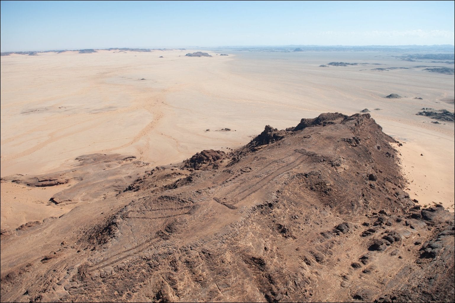 An aerial photograph of a group of several mustatils, created by a mysterious Arabian cult more than 7000 years ago. Credit: AAKSAU