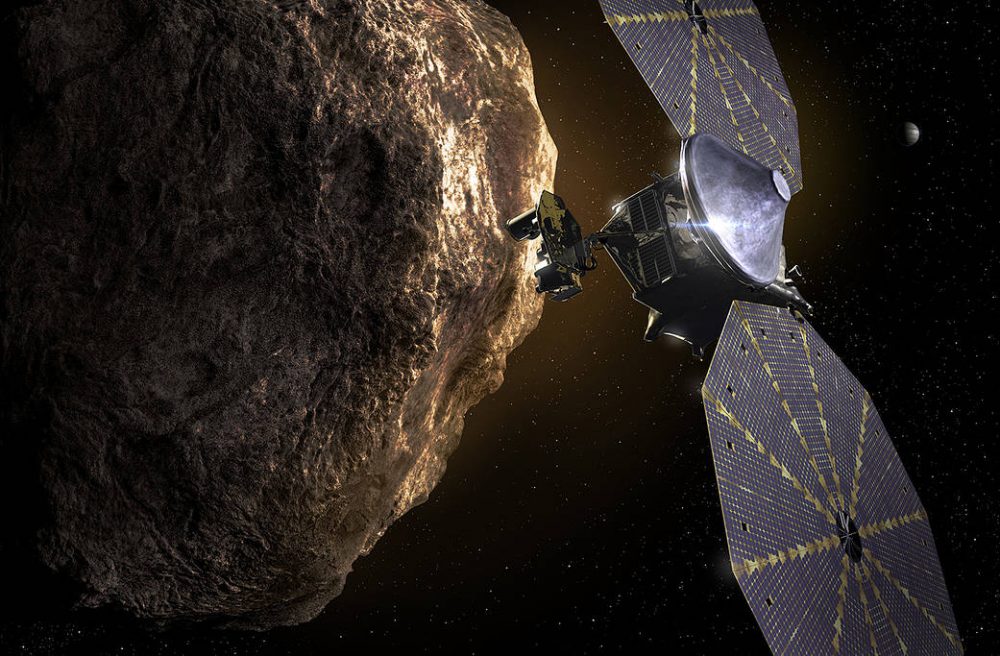 Artist's impression of the Lucy as it passes near a Trojan asteroid with Jupiter in the distant background. Credit: Southwest Research Institute