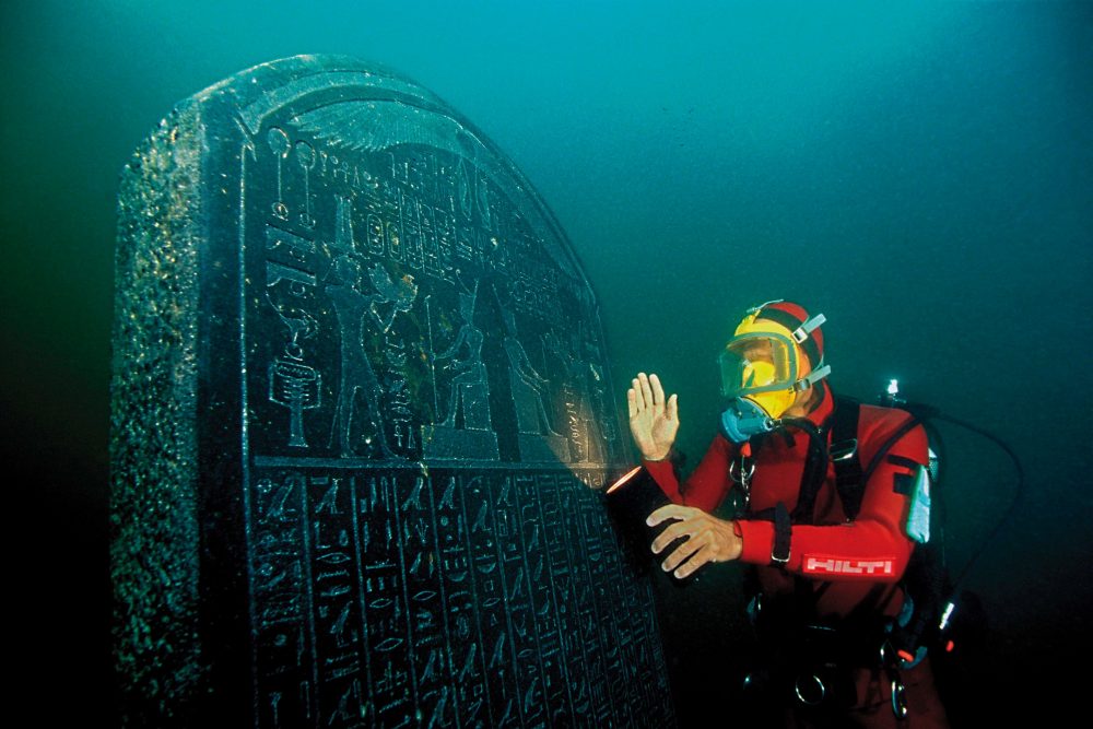Underwater archaeologist imaged next to a massive slab in Heracleion. Credit: Wikimedia Commons