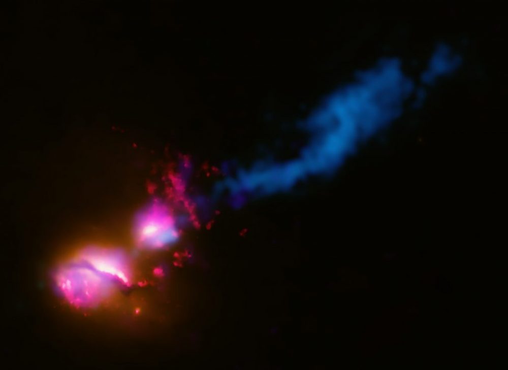 Composite image of radio galaxy 3C321 with X-ray data (colored purple), optical and UV (red and orange) and radio emissions (blue). Credit: X-ray: NASA/CXC/CfA/D.Evans et al.; Optical/UV: NASA/STScI; Radio: NSF/VLA/CfA/D.Evans et al., STFC/JBO/MERLIN