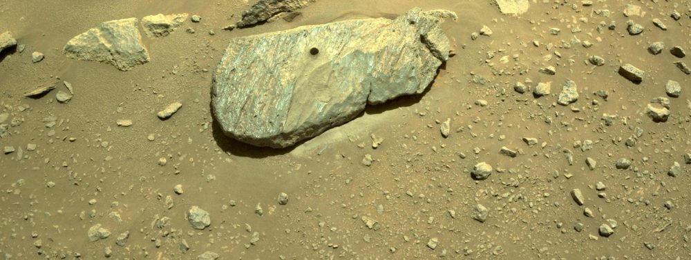 A boulder with a hole drilled by the Perseverance rover. Credit: NASA