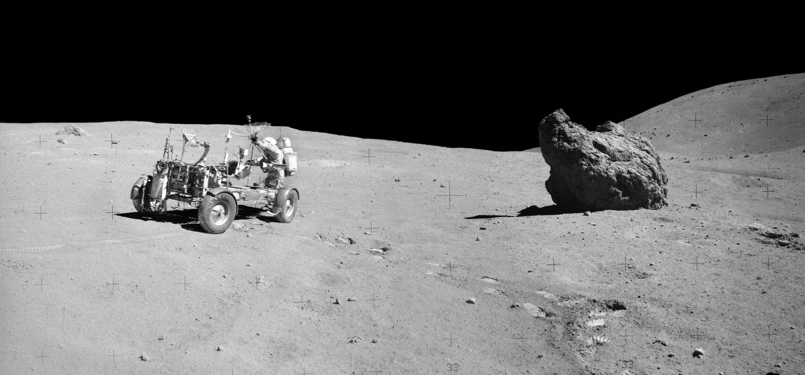 A photograph of Commander John Young inside the rover, next to the so-called "shadow rock." NASA.