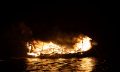 An ancient ship on fire. Greek fire weapon. Depositphotos.