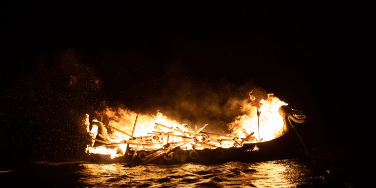 An ancient ship on fire. Greek fire weapon. Depositphotos.