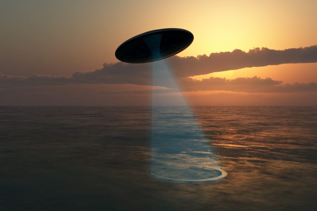 An illustration showing a UFO above the ocean. Depositphotos.