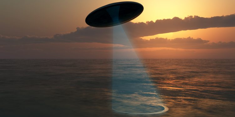 An illustration showing a UFO above the ocean. Depositphotos.