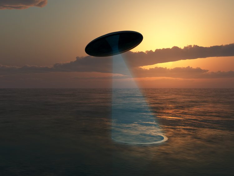 An illustration showing a UFO above the ocean. Depositphotos.