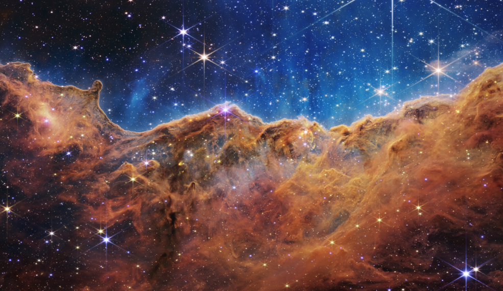An edge of young, star-forming regions called NGC 3324 in the Carina Nebula can be seen in front of these "mountains" and "valleys," speckled with glittering stars. For the first time, NASA's new James Webb Space Telescope is capturing infrared images to reveal previously invisible star birth areas. Image Credits: NASA, ESA, CSA, and STScI