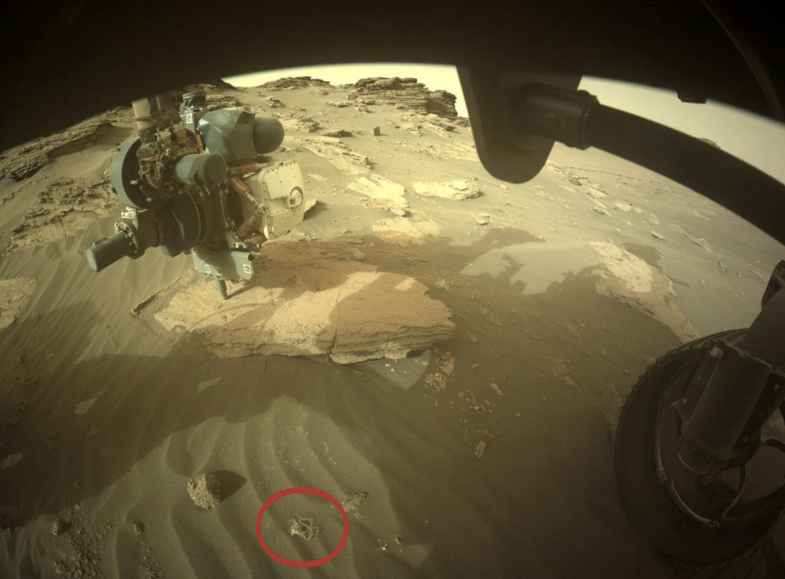 Taking a look at this image from July 12, 2022, we can see the out-of-place object (in red) in context with the wheel of the rover. NASA.