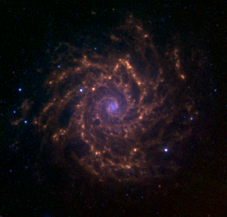 This image shows M74 as observed by the Spitzer Space Telescope as part of the Spitzer Nearby Galaxy Survey in the infrared. 3.6 micrometre emission from stars is represented by the blue colors. Green and red represent polycyclic aromatic hydrocarbons and dust emission at 5.8 and 8.0 micrometres, respectively. Image Credit: NASA.