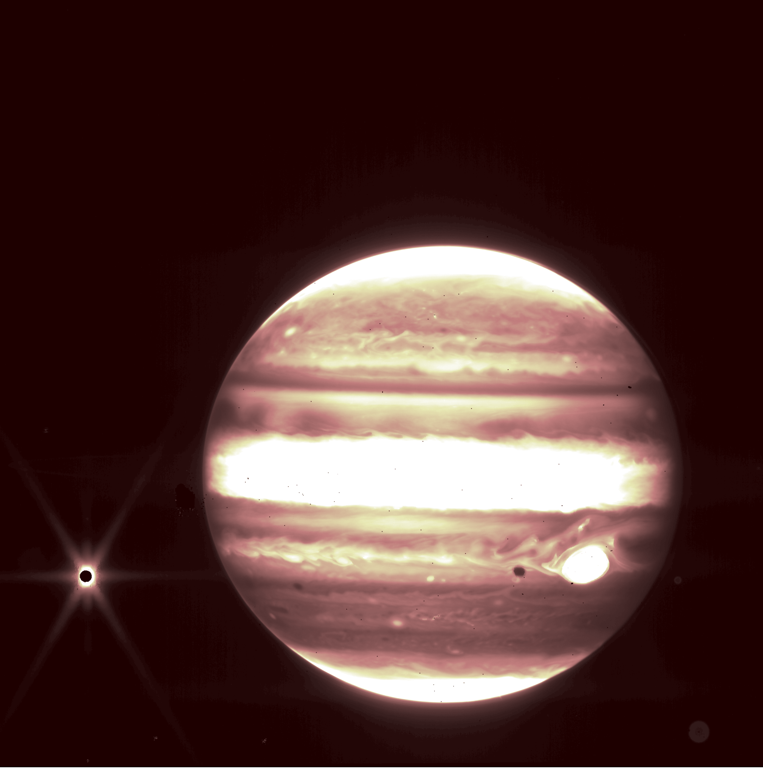 Jupiter, center, and its moon Europa, left, are viewed through the 2.12 micron NIRCam filter on the James Webb Space Telescope. Credits: NASA, ESA, CSA, and B. Holler and J. Stansberry (STScI).