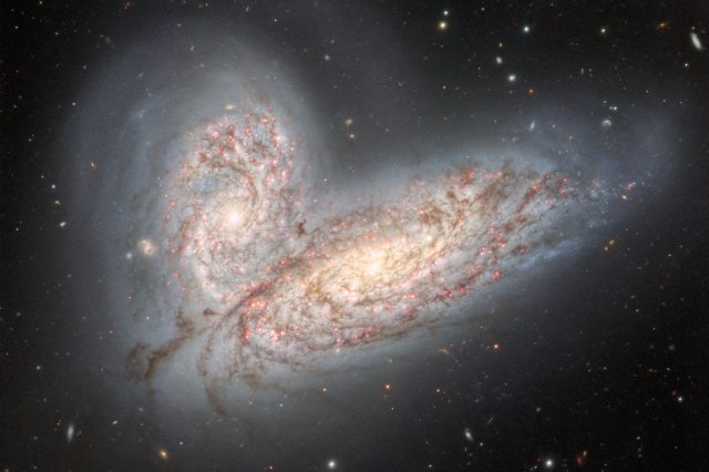 This image from Gemini North in Hawaii shows two spiral galaxies on the verge of merging and clashing - NGC 4568 (bottom) and NGC 4567 (top). It will take around 500 million years for the galaxies to merge into a single elliptical galaxy. Credit: International Gemini Observatory/NOIRLab/NSF/AURA.