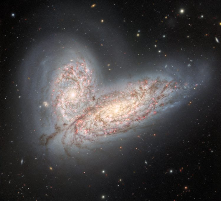 This image from Gemini North in Hawaii shows two spiral galaxies on the verge of merging and clashing - NGC 4568 (bottom) and NGC 4567 (top). It will take around 500 million years for the galaxies to merge into a single elliptical galaxy. Credit: International Gemini Observatory/NOIRLab/NSF/AURA.