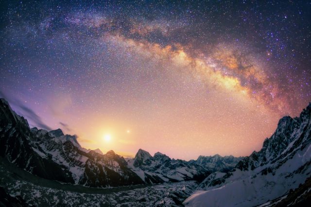 A photograph of the Milky Way rising above the horizon. Depositphotos.