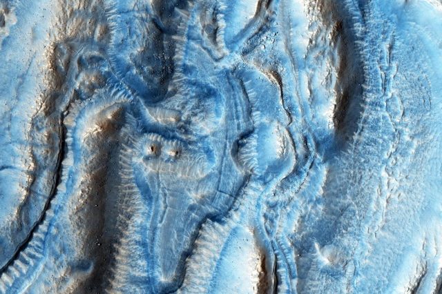 An aerial view of the colorful landscape on Mars. Image Credit: NASA/JPL-CalTech/University of Arizona.