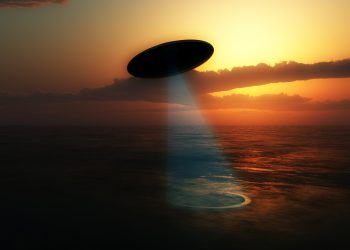 Illustration of a UFO absorbing water from a lake. Depositphotos.