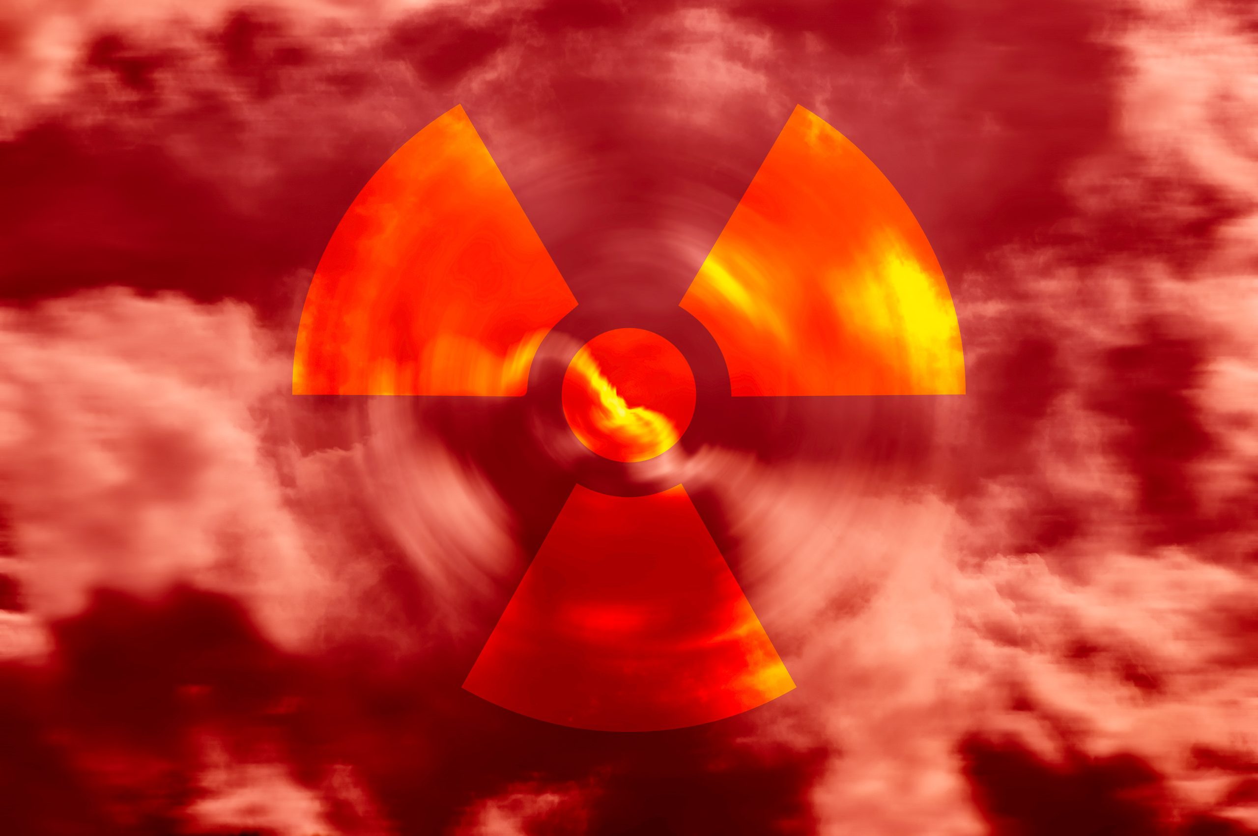 Radioactive symbol in a red sky with clouds. YAYIMAGES.