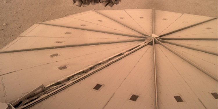 A photograph by InSight showing its solar panels covered in dust. Credit: NASA.