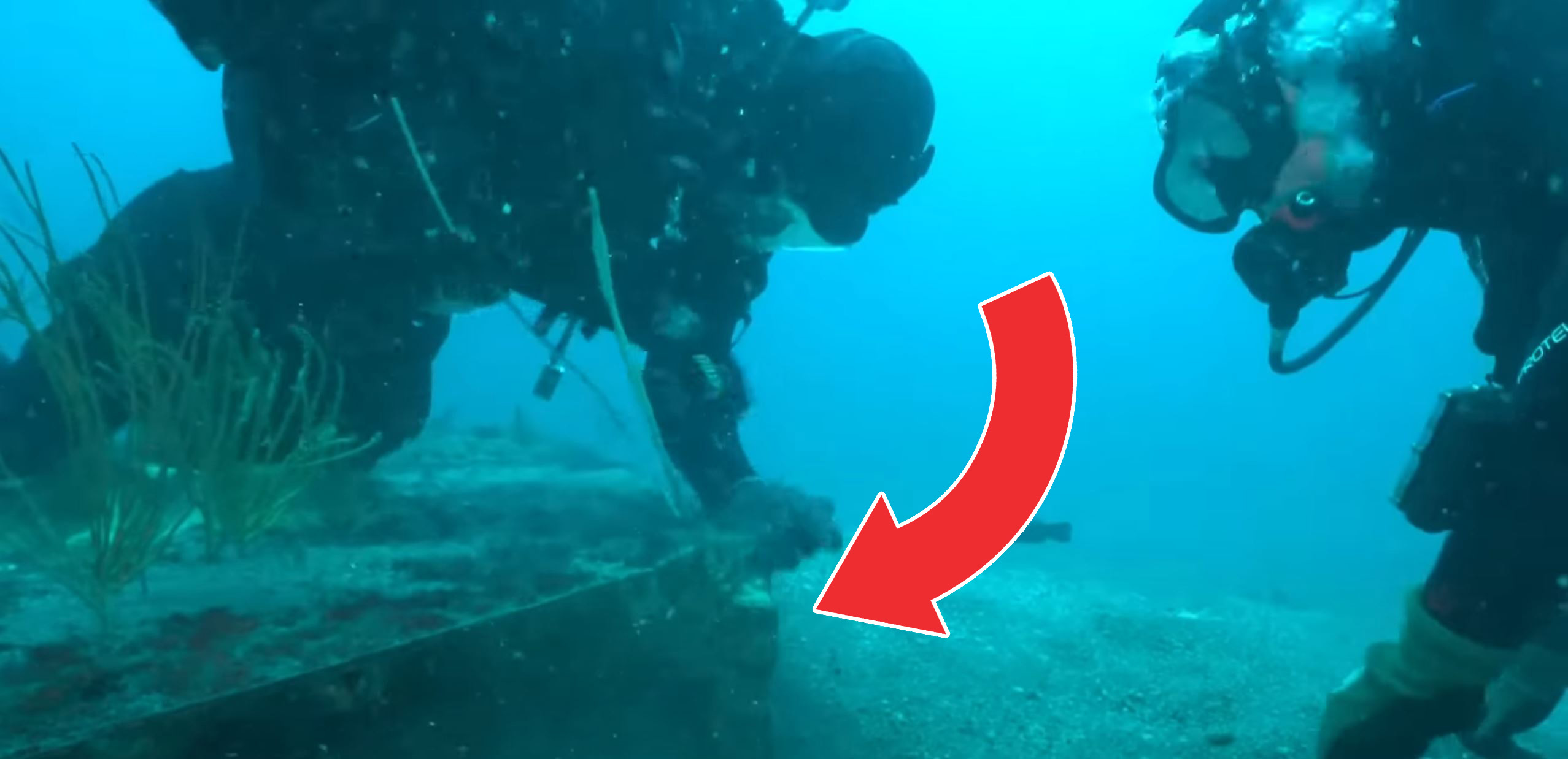 A screenshot showing divers and the spaceship wreckage. YouTube/History.
