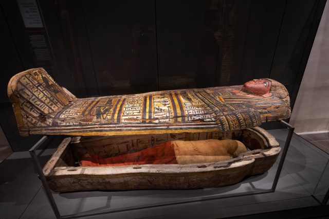 A photograph of an ancient Egyptian mummy and sarcophagus. Yayimages.