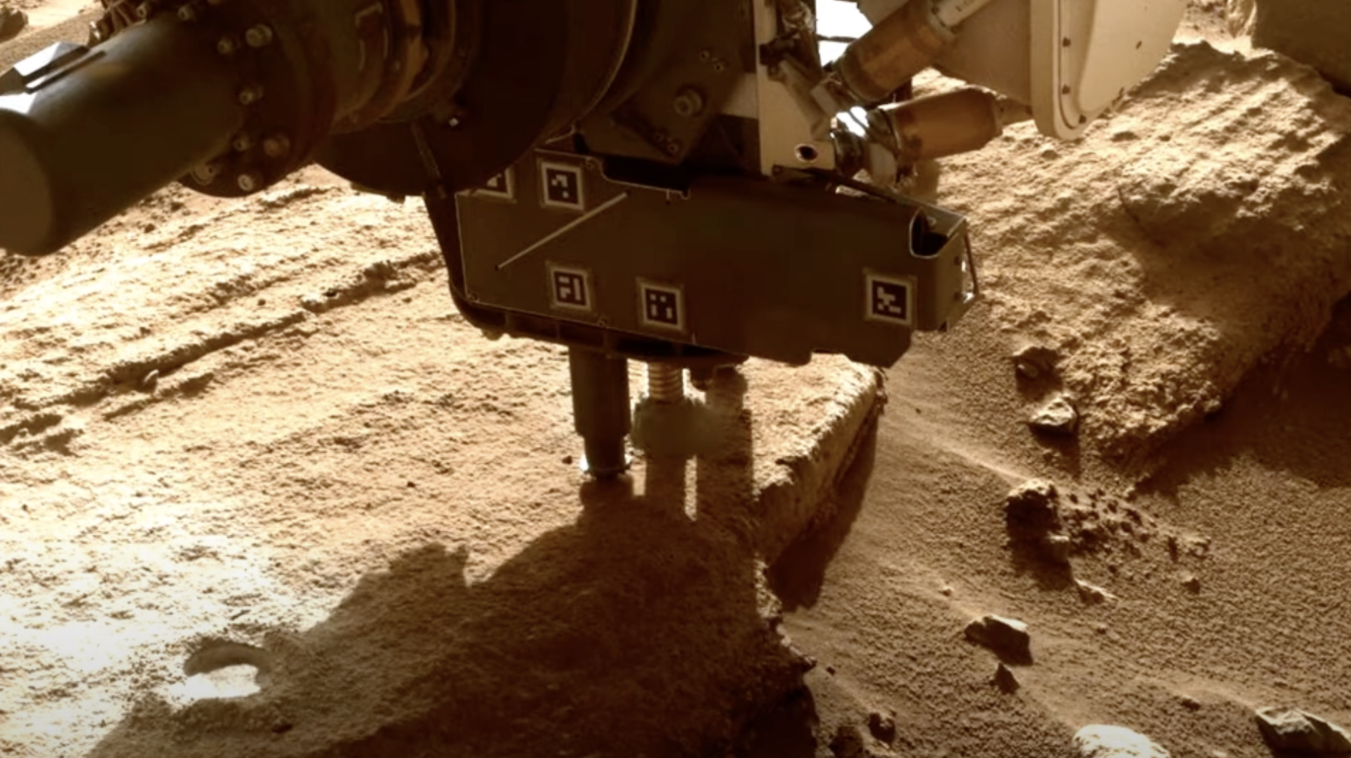 A photograph of Perseverance drilling an ancient river on Mars