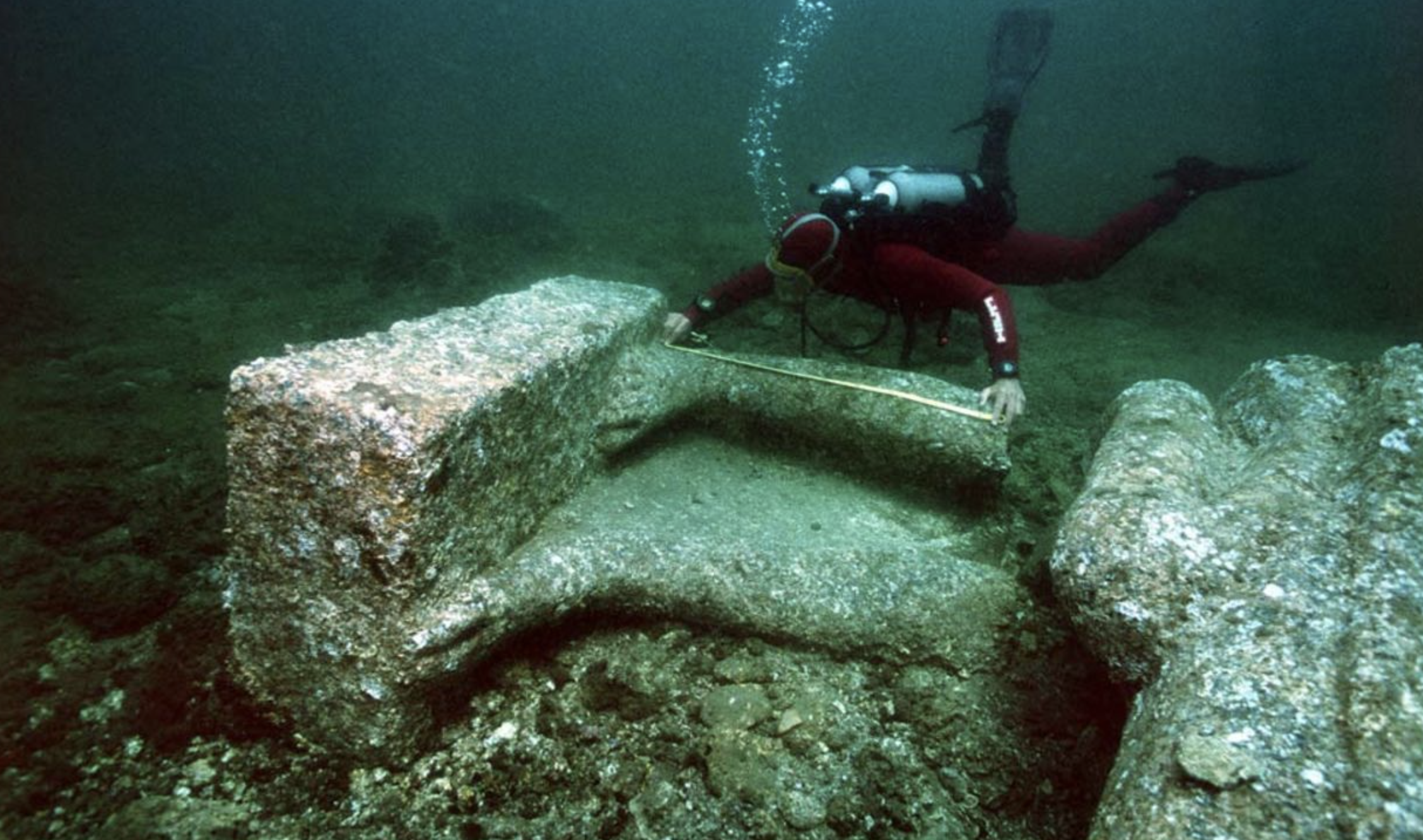 At Thonis-Heracleion in the Bay of Aboukir, an archaeologist carefully measures the feet and other fragments of a massive statue. These measurements are taken after the initial cleaning process conducted on-site. Image Credit: Franck Goddio/Hilti Foundation, photo: Christoph Gerigk.