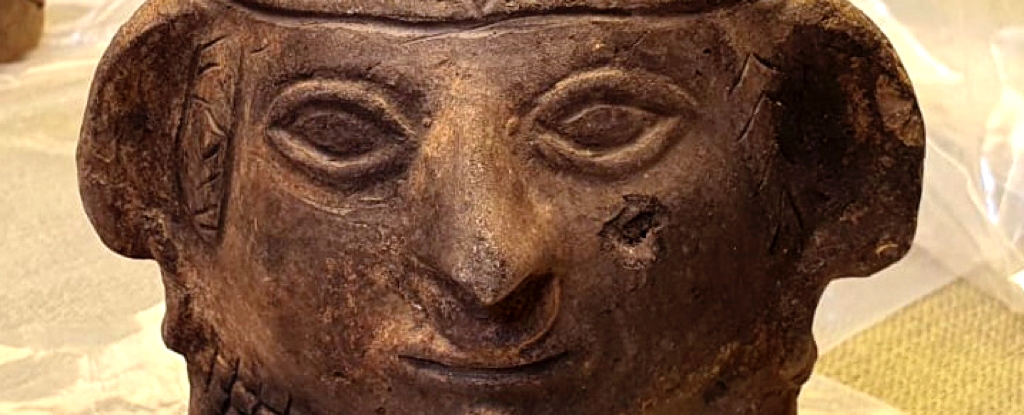 A decorative ceramic vase featuring a human visage was uncovered at the location. (Peruvian Ministry of Culture/AFP)