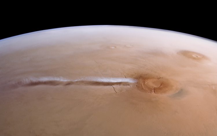 An elongated cloud has developed due to winds interacting with the Arsia Mons mountains. It forms nearly every day during a particular season, from the early morning hours until midday. Image credit: ESA/DLR/FU Berlin/A. Cowart.