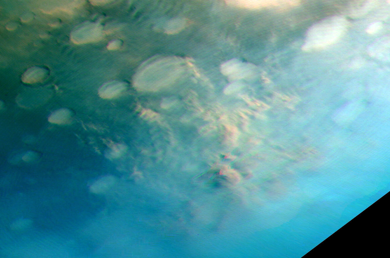 This image showcases two distinct atmospheric phenomena: the white, curved formations represent gravity wave clouds, while the brown regions depict dust being swept up from the surface by the wind. The noticeable color variation within the dust event could suggest extremely high wind speeds, a subject that is currently being studied by other team members. Image credit: ESA/DLR/FU Berlin.