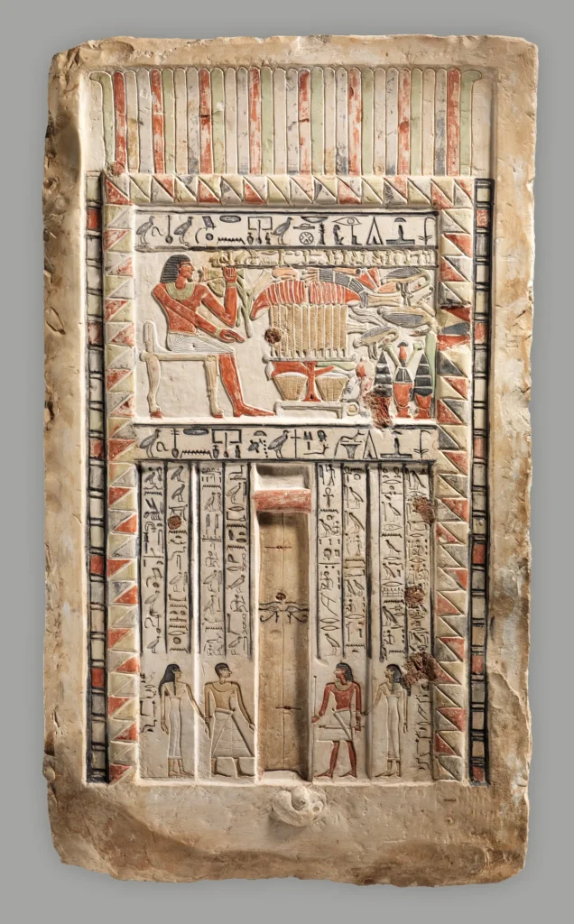 Painted limestone false door of the royal sealer Neferiu, with offering scenes and hieroglyphic inscriptions.