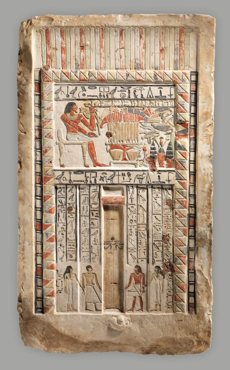 Painted limestone false door of the royal sealer Neferiu, with offering scenes and hieroglyphic inscriptions.