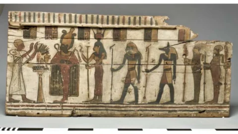 Ancient Egyptian painted coffin panel with figures and hieroglyphs