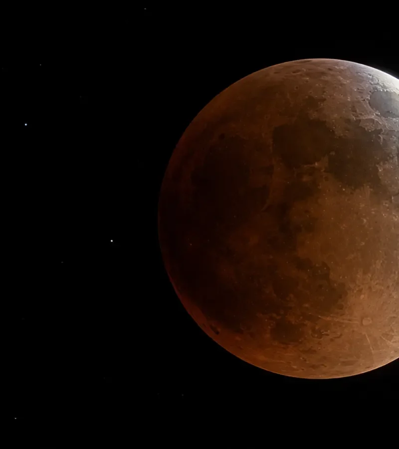 Conceptual view of a deep partial lunar eclipse as Earth’s shadow crosses the full Moon.