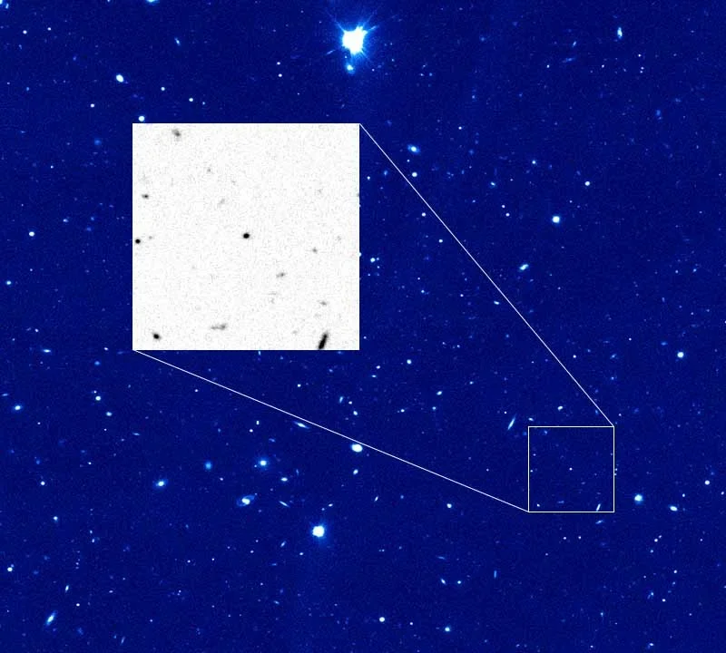 A star field with a small comet inset showing the nucleus of comet 28P
