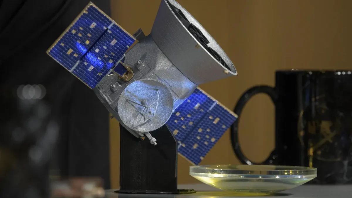 NASA illustration of the TESS spacecraft searching for planets around distant stars