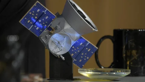 NASA illustration of the TESS spacecraft searching for planets around distant stars