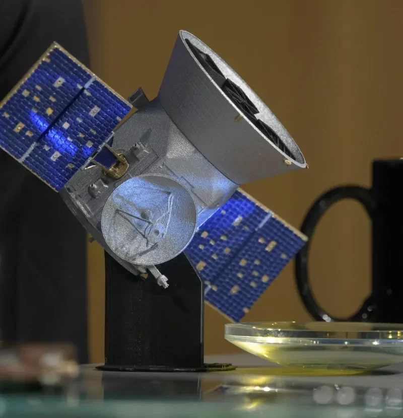 NASA illustration of the TESS spacecraft searching for planets around distant stars