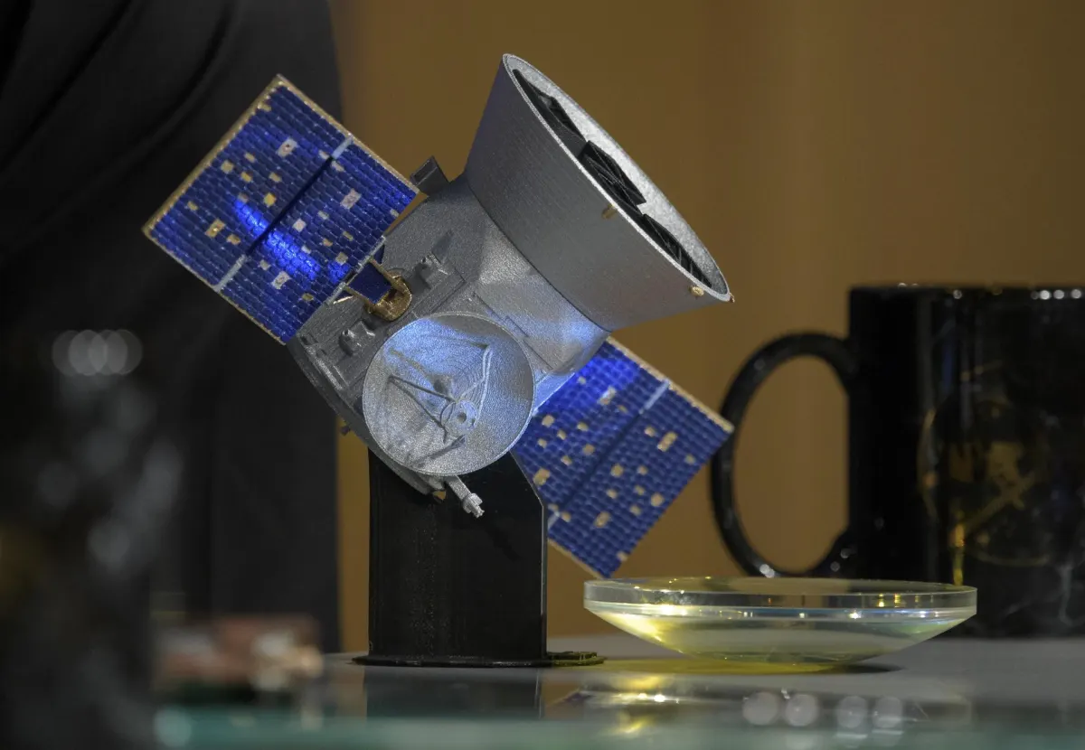 NASA illustration of the TESS spacecraft searching for planets around distant stars